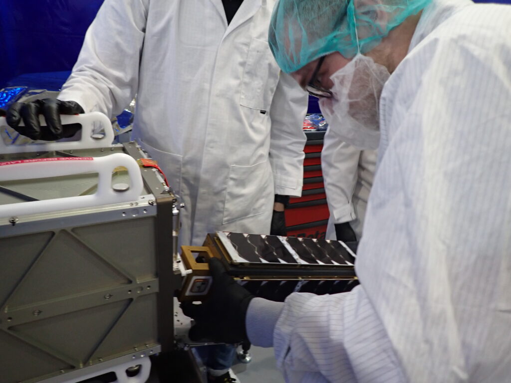 Outpost Mission 1 being integrated into the cubesat dispenser